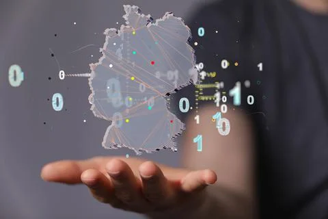 A hologram of the map of Germany with binary codes on a woman's palm - nation Stock Photos