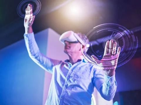 Hologram, metaverse and virtual reality with a senior man using a vr headset to Stock Photos