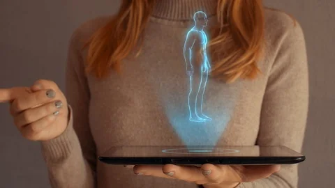 Hologram screen on a tablet with digital human body, skeleton and brain. Видео 104931827