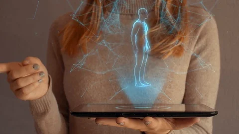 Hologram screen on a tablet with digital human body, skeleton and brain. 스톡 동영상 104932192