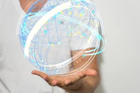 A hologram of a sphere made of interconnected dots on a man's palm - global n Stock Photos