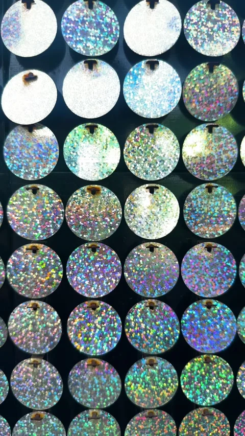 Holographic glitter sequins creating a vibrant light reflecting disco ball Stock Footage 329474398