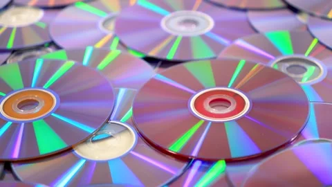 Holographic light reflecting on a pile of compact discs 스톡 동영상 339231241