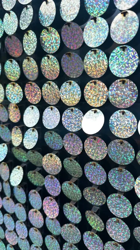 Holographic sequins are shimmering, creating a dynamic, glittering background Stock Footage 329488501