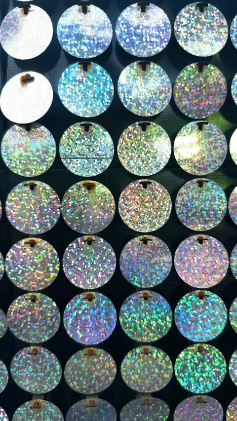 Holographic sequins creating a vibrant and dynamic background, reflecting light Stock Footage 329474509