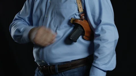 Holstering a hangun Stock Footage 113878002