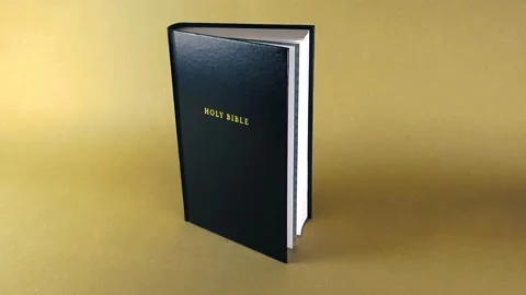 Holy Bible gliding camera shot on light brown background Stock Footage 343371407