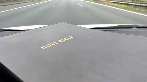 Holy Bible inside the car running on the expressway Stock Footage 154811132