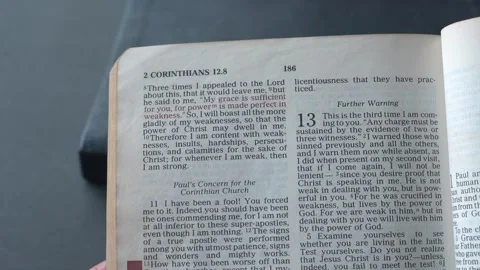 Holy bible open up to the book of 2 Corinthians Chapter 12. Video stock 335628955