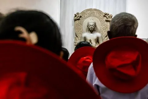 Holy buddha statue in preaching pose with devotees from unique perspective 스톡 사진