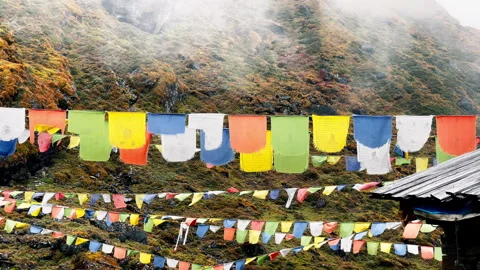 Holy buddhist praying multicolored flags with mantras flapping and waving on the 스톡 동영상 262340787