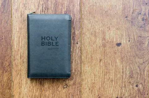 Holy Christian leather bound bible on a wooden background Stock Photos
