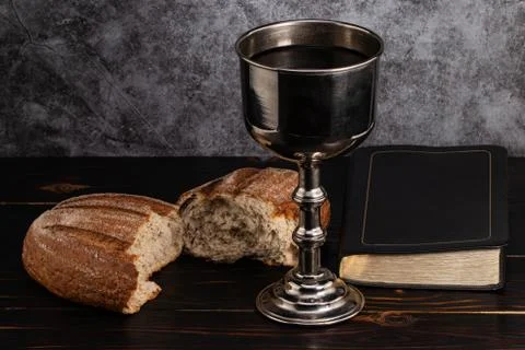 Holy communion chalice with wine and bread Stock Photos
