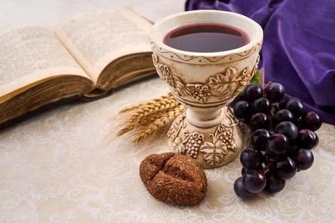 Holy communion elements with bible, chalice, and grapes 스톡 사진
