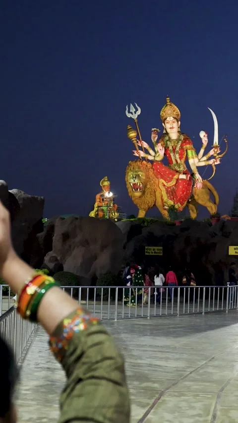Holy durga idol with devotee at temple courtyard at night Stock Footage 340814384