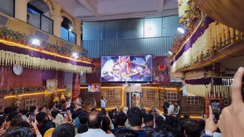 Holy hindu temple with devotee crowed at holy aarti or ceremony of light at Stock Footage 309792948