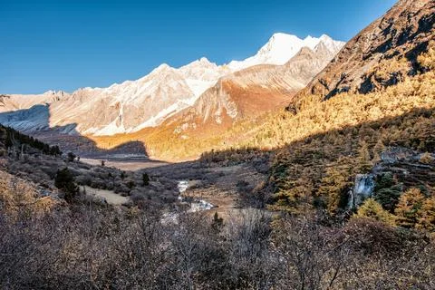 Holy mountain range with waterfall in pine forest in autumn Stock Photos
