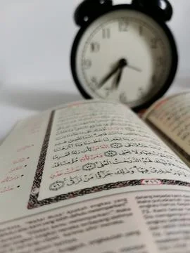 Holy Quran with Arabic calligraphy and o'clock Stock Photos