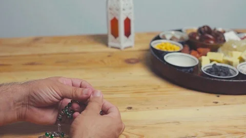 Holy Ramadan month. A prayer counting praying rosary beads in hands before Stock Footage 129361603