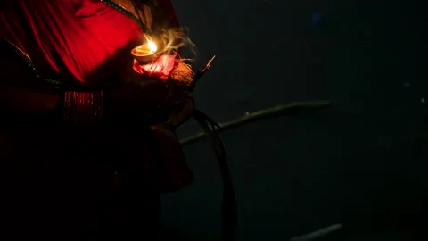 Holy ritual of devotee offering diya at riverside chhath puja prayer Stock Footage 316674572