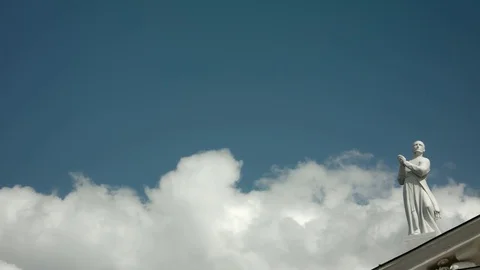 Holy statue in front of yellow ribbon and blue sky – medium shot Stock Footage 80744066