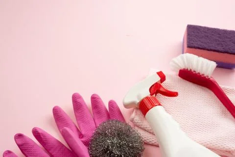 Home accessories lie on a flat surface: washcloth, cleaning brush, latex glov Stock Photos