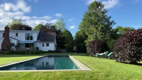 Home activity two men in lovely backyard during summer day - affluent suburban Stock Footage 201253457