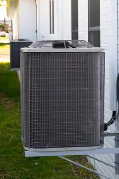 Home air conditioner compressor system in backyard Stock Photos