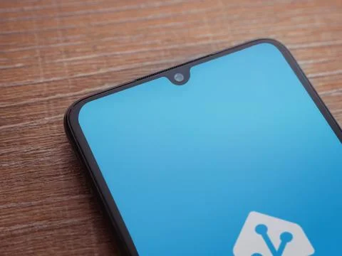 Home Assistant app launch screen on smartphone on wooden background Stock Photos