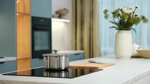 Home background, the interior of a cozy kitchen, a saucepan is on the stove Stock Footage 253174423