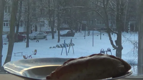 Home baking on the background of the window, yard, winter 스톡 동영상 168988046