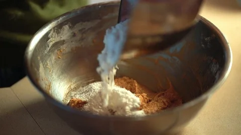 Home baking - putting flour into the cookie dough mix for homemade cookies 動画素材 94038566