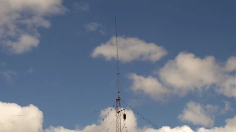 Home based single spike antenna tower heavy clouds day time lapse Stock Footage 68775358