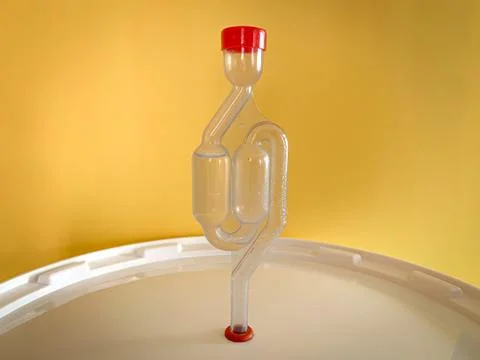 Home beer brewery in progress, bubbling airlock on fermentation container. Wi Stock Photos