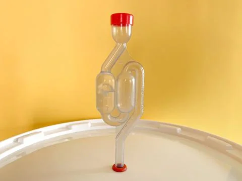 Home beer brewery in progress, bubbling airlock on fermentation container. Wi Stock Photos
