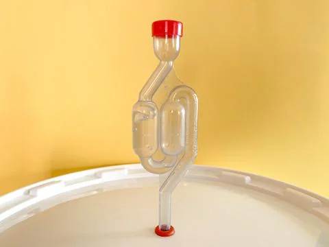 Home beer brewery in progress, bubbling airlock on fermentation container. Wi Stock Photos