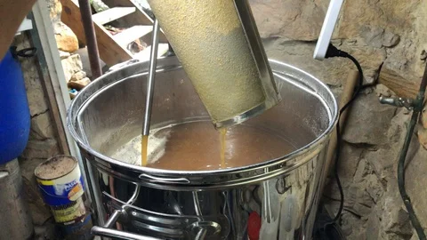 Home beer brewing draining filter into wort kettle Stock Footage 127829070