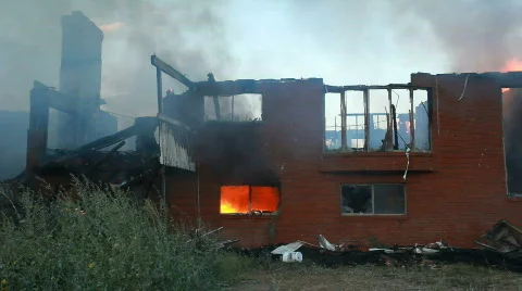 Home burning flames in window P HD 0757 Stock Footage