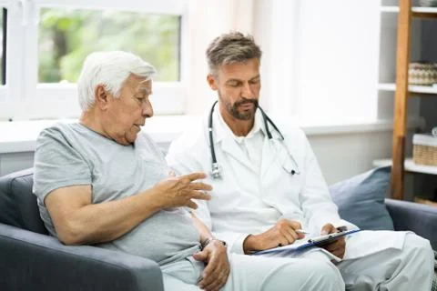 Home Care Elder Patient Talking To Doctor Stock Photos