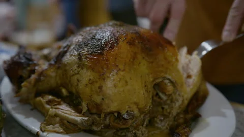 Home celebration, hands start cutting baked chicken. roasted whole tur Stock-Footage 327252913