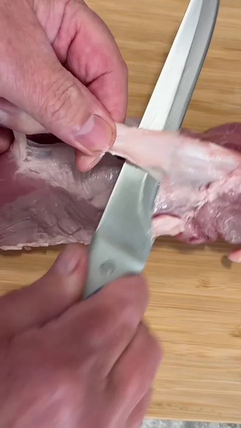 Home Chef Trimming Tough Silver Skin from Pork Tenderloin Close Up 4K Vertical Stock Footage 337797161