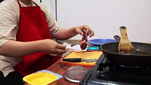 Home Chef wearing apron carefully pat-dries fresh raw steak with paper towel on Stock Footage 345379716