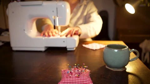 Home Clothes Repair Using Sewing Machine, Selective Focus On Pin Cusion Stock Footage 296703228