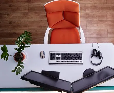 Home computer workstation top view. A wheeled chair, a large white desk, and two Stock Photos