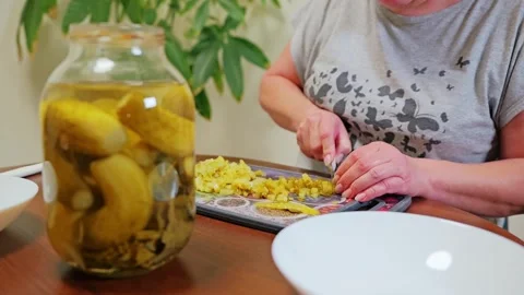 Home Cook Chops Pickled Cucumbers Into Small Cubes For Traditional Russian Salad Stock Footage 344008146