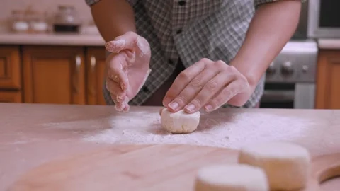 Home Cook Meticulously Forms Dough Pieces For Baking Or Frying Tasks 動画素材 331148230
