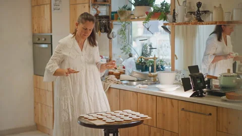 Home cook preparing festive pumpkin desserts. Warm seasonal baking scene with Stock Footage 346409891