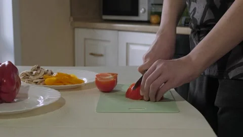 Home cook slicing tomato on kitchen Stock Footage 339972981