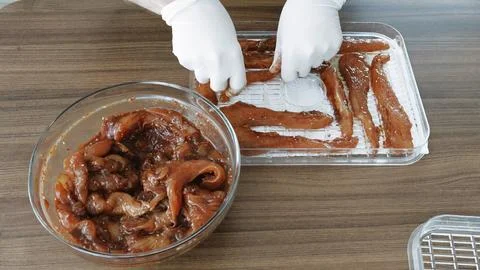 Home cooking Chicken slices while dehydrating making jerky in Dehydrator. Stock Photos