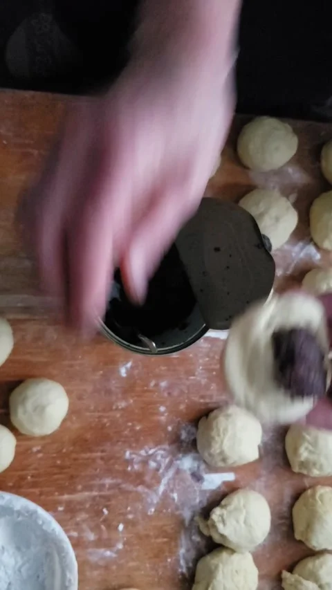 Home cooking, making doe balls with chocolate filling Stock Footage 260978123